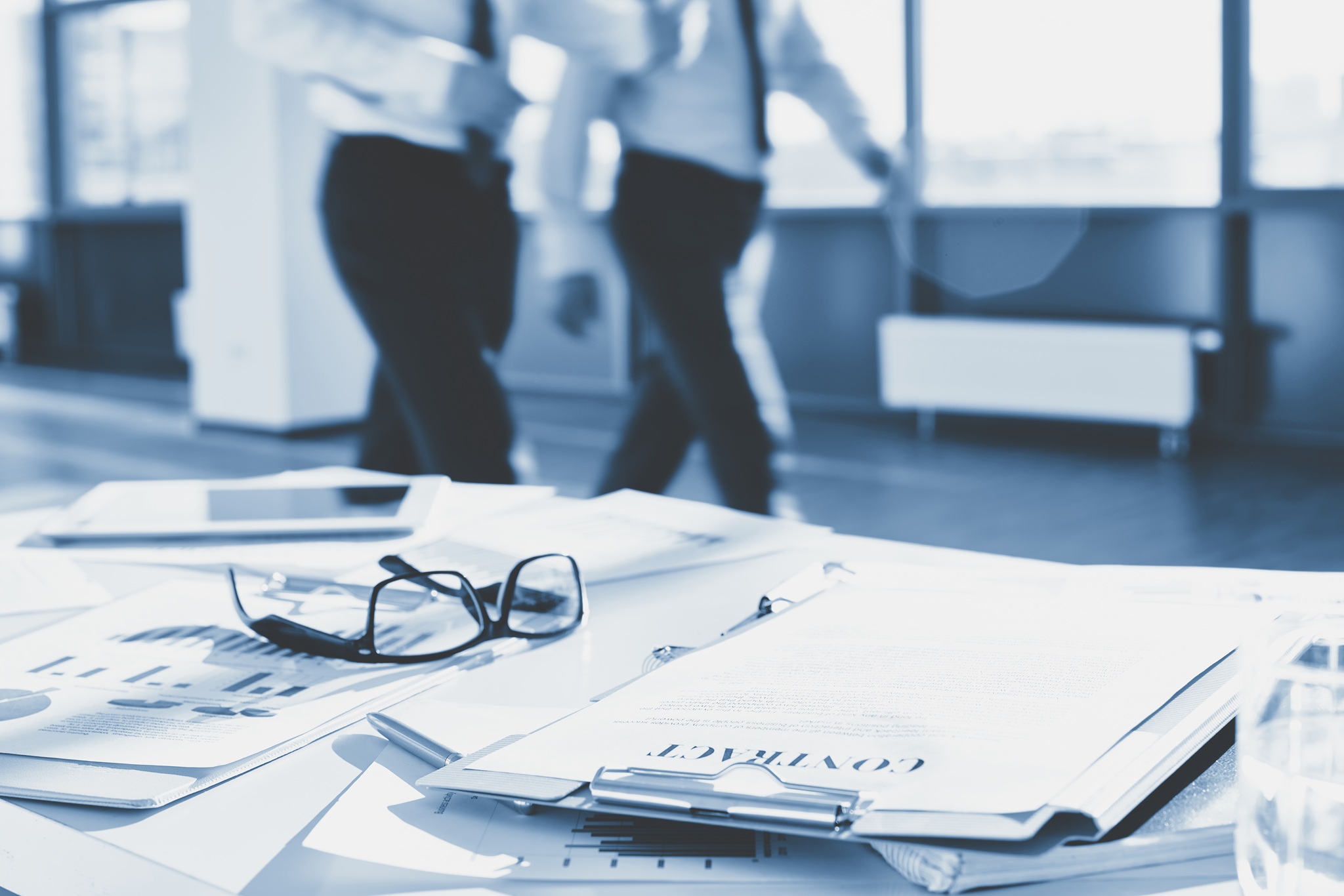 Business documents and eyeglasses on the desk in office
